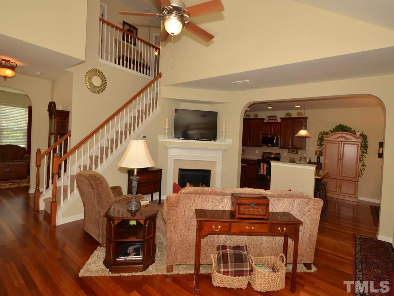 9714 Renfield Drive Raleigh, NC 27617 - Photo 5 of 25 a view of a livingroom with furniture fireplace wooden floor and windows