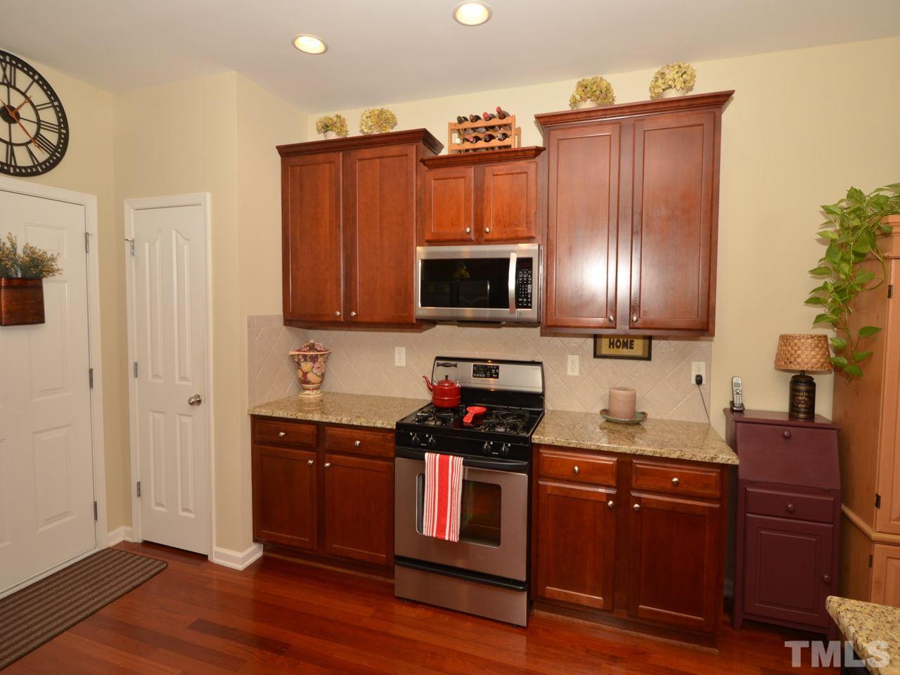 9714 Renfield Drive Raleigh, NC 27617 - Photo 7 of 25 a kitchen with granite countertop stainless steel appliances and wooden cabinets