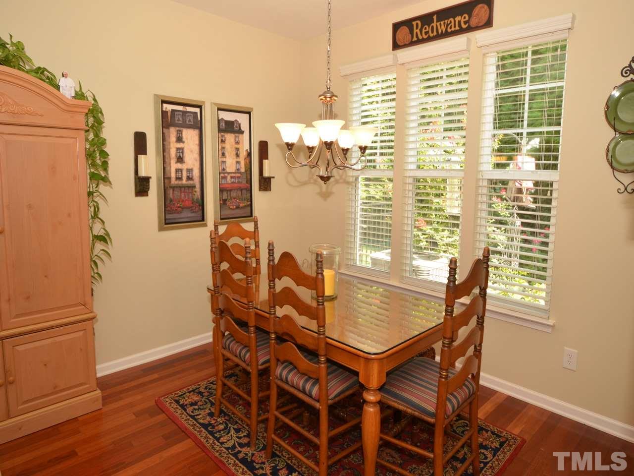 9714 Renfield Drive Raleigh, NC 27617 - Photo 8 of 25 a view of a dining room with furniture window and wooden floor
