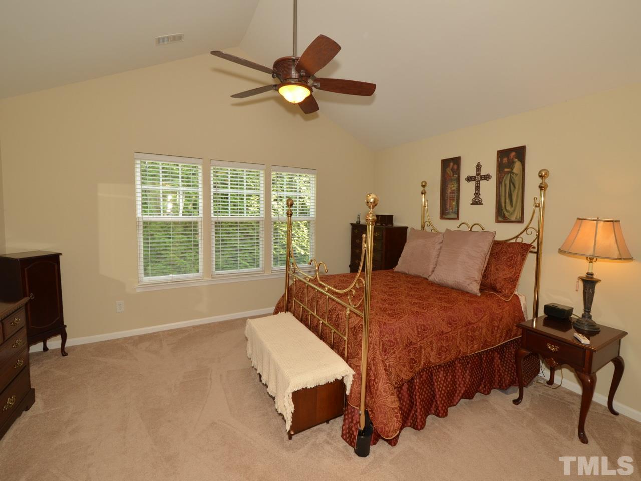 9714 Renfield Drive Raleigh, NC 27617 - Photo 9 of 25 a bedroom with a bed and a window