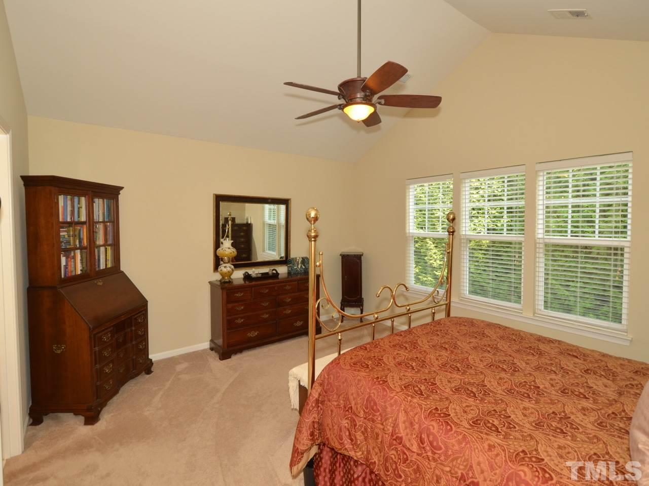 9714 Renfield Drive Raleigh, NC 27617 - Photo 10 of 25 a bedroom with a bed and a television
