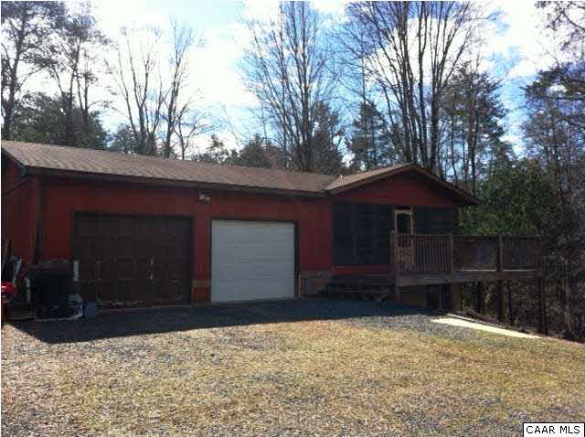 2188 Middle River Road Stanardsville, VA 22973 - Photo 1 of 13 a house with trees in the background