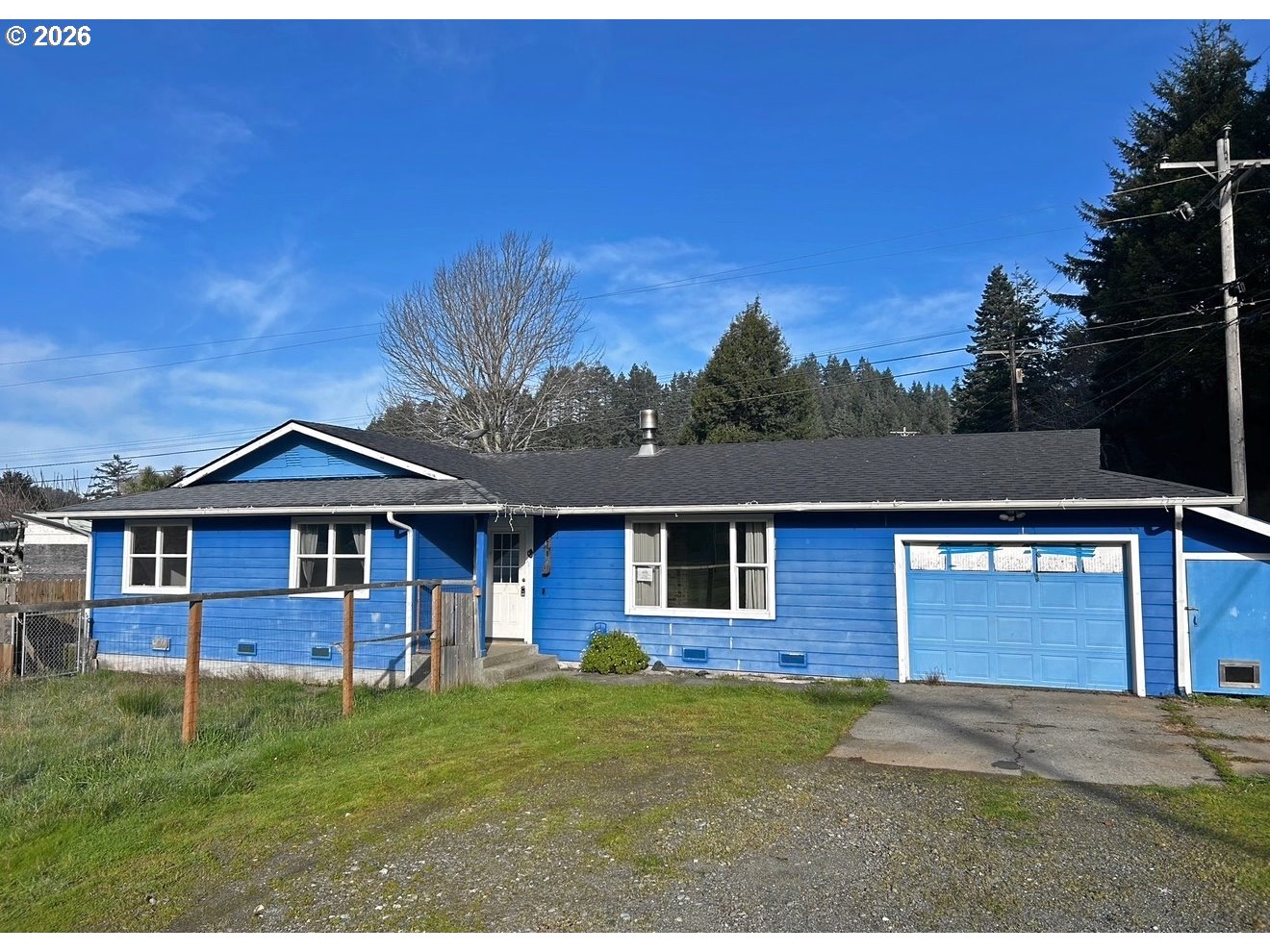 28218 Mateer Road Gold Beach, OR 97444 - Photo 1 of 20 a front view of a house with a garden
