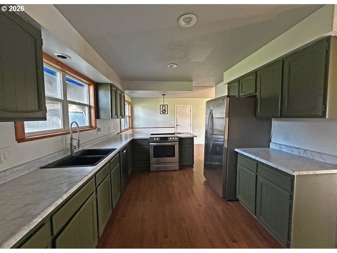 28218 Mateer Road Gold Beach, OR 97444 - Photo 11 of 20 a kitchen with granite countertop a sink cabinets and stainless steel appliances