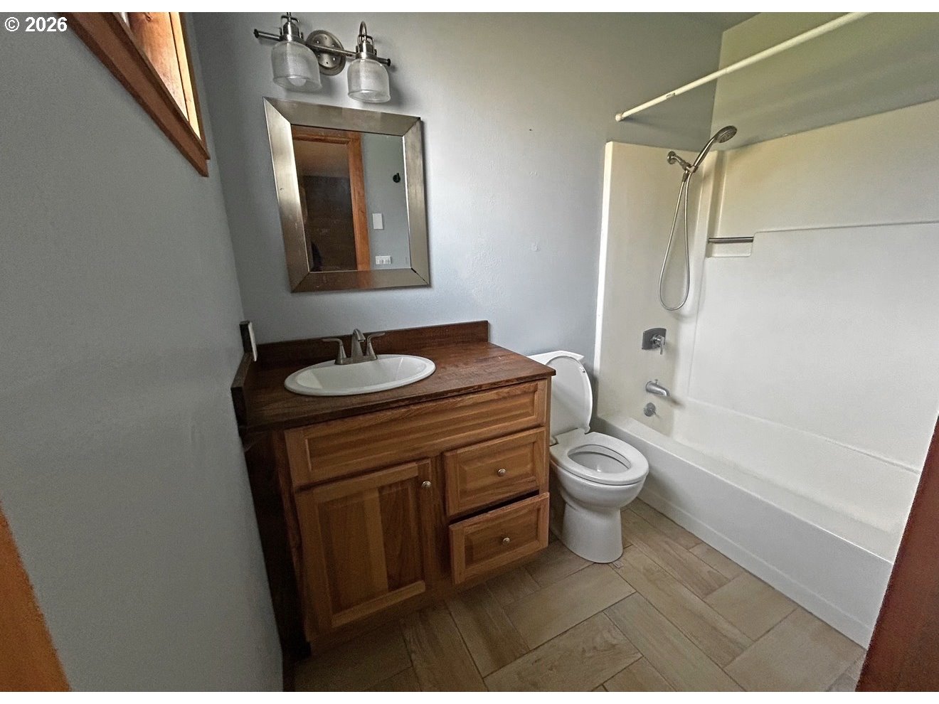 28218 Mateer Road Gold Beach, OR 97444 - Photo 15 of 20 a bathroom with a granite countertop sink toilet a shower and a mirror