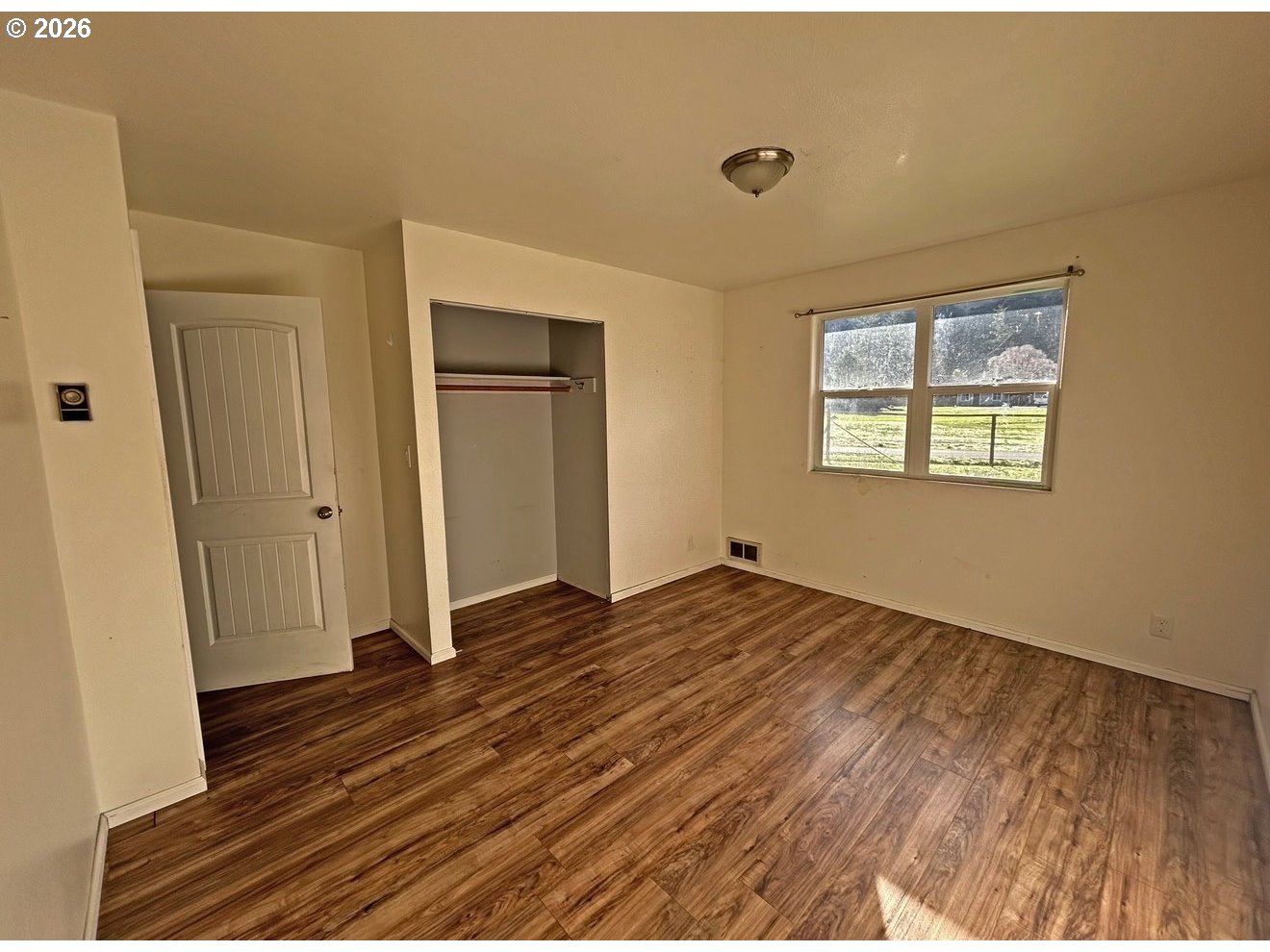 28218 Mateer Road Gold Beach, OR 97444 - Photo 19 of 20 a view of empty room with wooden floor and fan