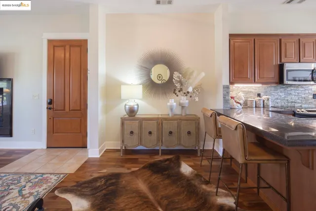 a dining room with furniture and wooden floor