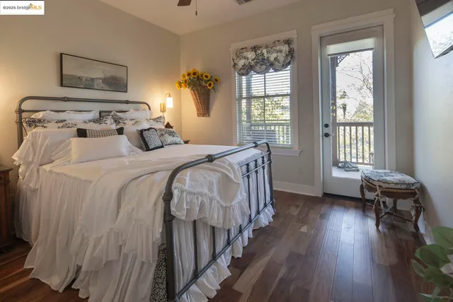 a bedroom with a bed tv and window