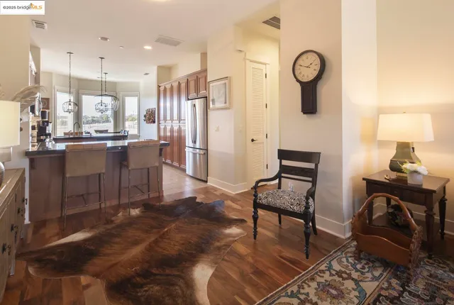 a living room with furniture a rug and kitchen view