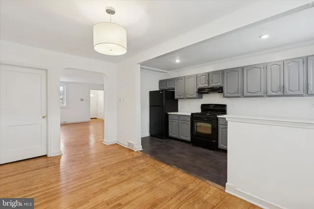 a kitchen with granite countertop white cabinets and stainless steel appliances