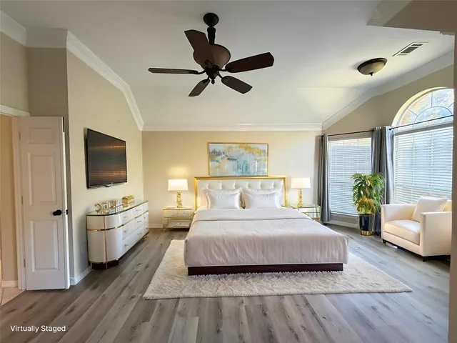 a bedroom with a bed and ceiling fan