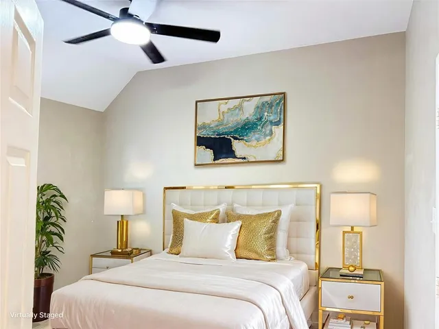 a bedroom with a bed and a lamp