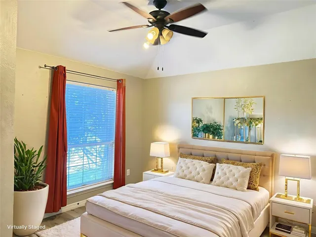 a bedroom with a large bed and a chandelier