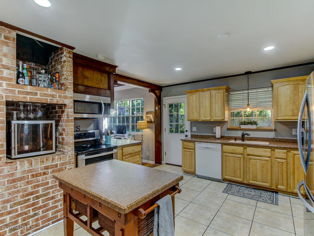 1041 Glen Echo Road Jacksonville, FL 32211 - Photo 12 of 40 a kitchen with stainless steel appliances granite countertop a stove top oven a sink dishwasher and cabinets with wooden floor
