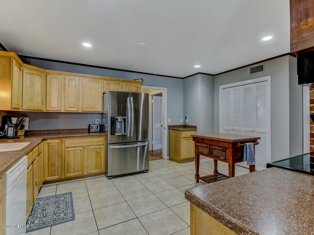 1041 Glen Echo Road Jacksonville, FL 32211 - Photo 13 of 40 a kitchen with refrigerator and cabinets