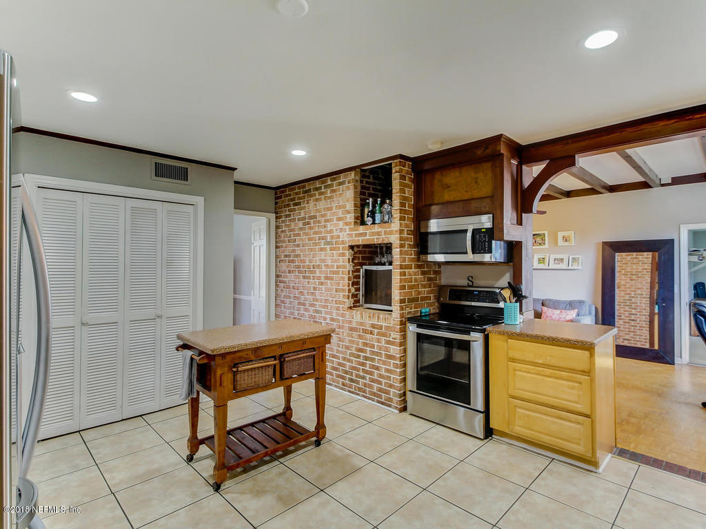 1041 Glen Echo Road Jacksonville, FL 32211 - Photo 14 of 40 a kitchen with stainless steel appliances kitchen island granite countertop a refrigerator and cabinets