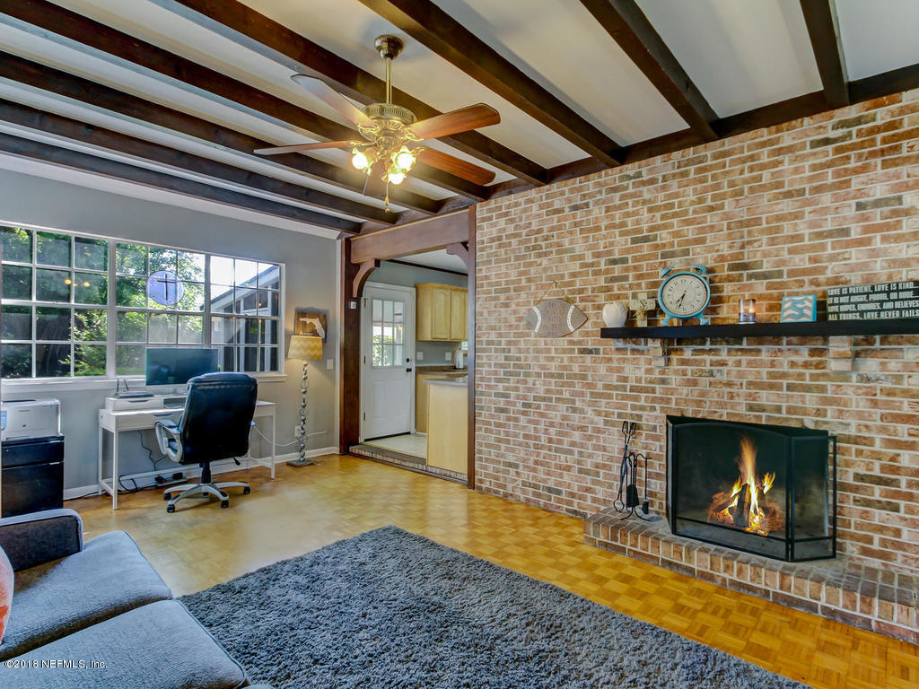 1041 Glen Echo Road Jacksonville, FL 32211 - Photo 18 of 40 a living room with furniture wooden floor and a fireplace