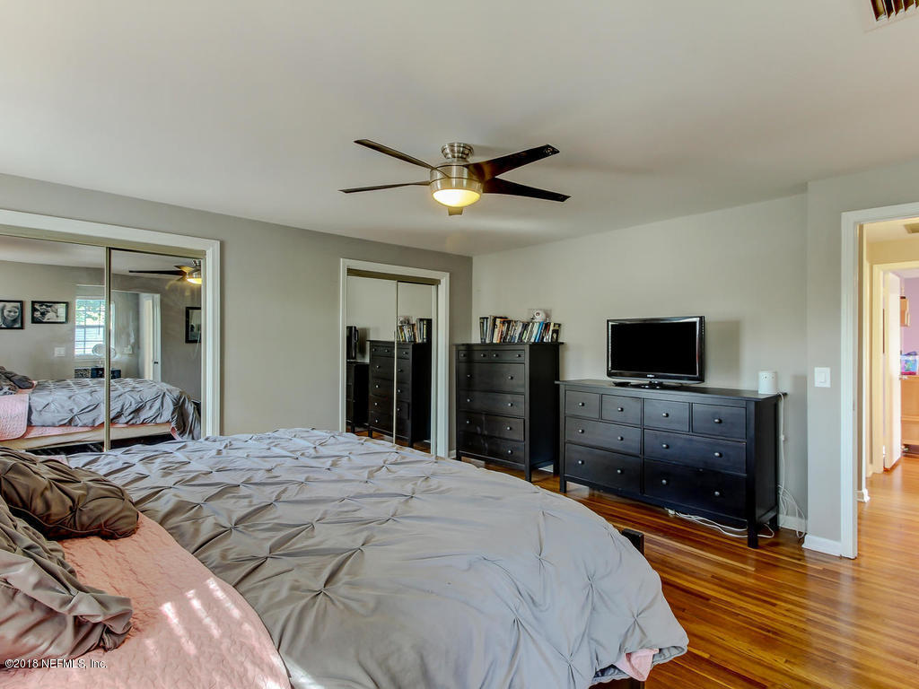 1041 Glen Echo Road Jacksonville, FL 32211 - Photo 20 of 40 a bedroom with a bed and a flat screen tv