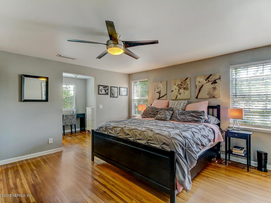 1041 Glen Echo Road Jacksonville, FL 32211 - Photo 21 of 40 a bedroom with a bed and a chandelier