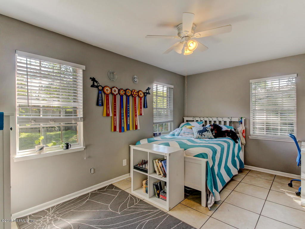 1041 Glen Echo Road Jacksonville, FL 32211 - Photo 24 of 40 a bedroom with a bed and a chandelier