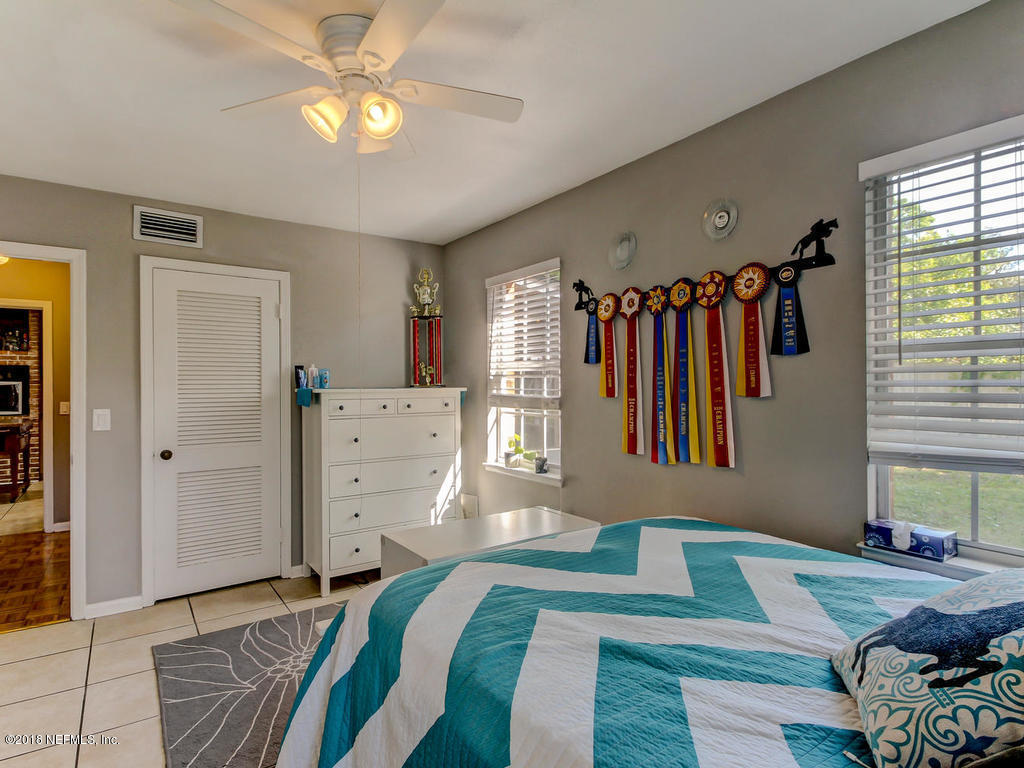 1041 Glen Echo Road Jacksonville, FL 32211 - Photo 25 of 40 a bedroom with a bed closet and a window