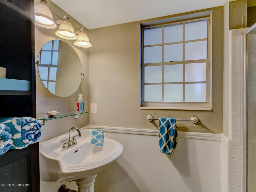 1041 Glen Echo Road Jacksonville, FL 32211 - Photo 26 of 40 a bathroom with a sink and a mirror