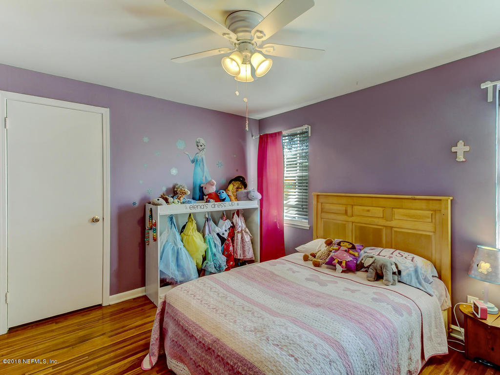 1041 Glen Echo Road Jacksonville, FL 32211 - Photo 29 of 40 a bedroom with a bed and a chandelier