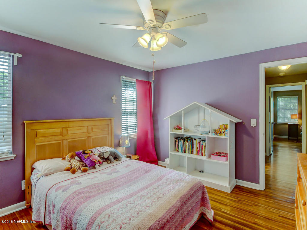 1041 Glen Echo Road Jacksonville, FL 32211 - Photo 30 of 40 a bedroom with a bed and a chandelier