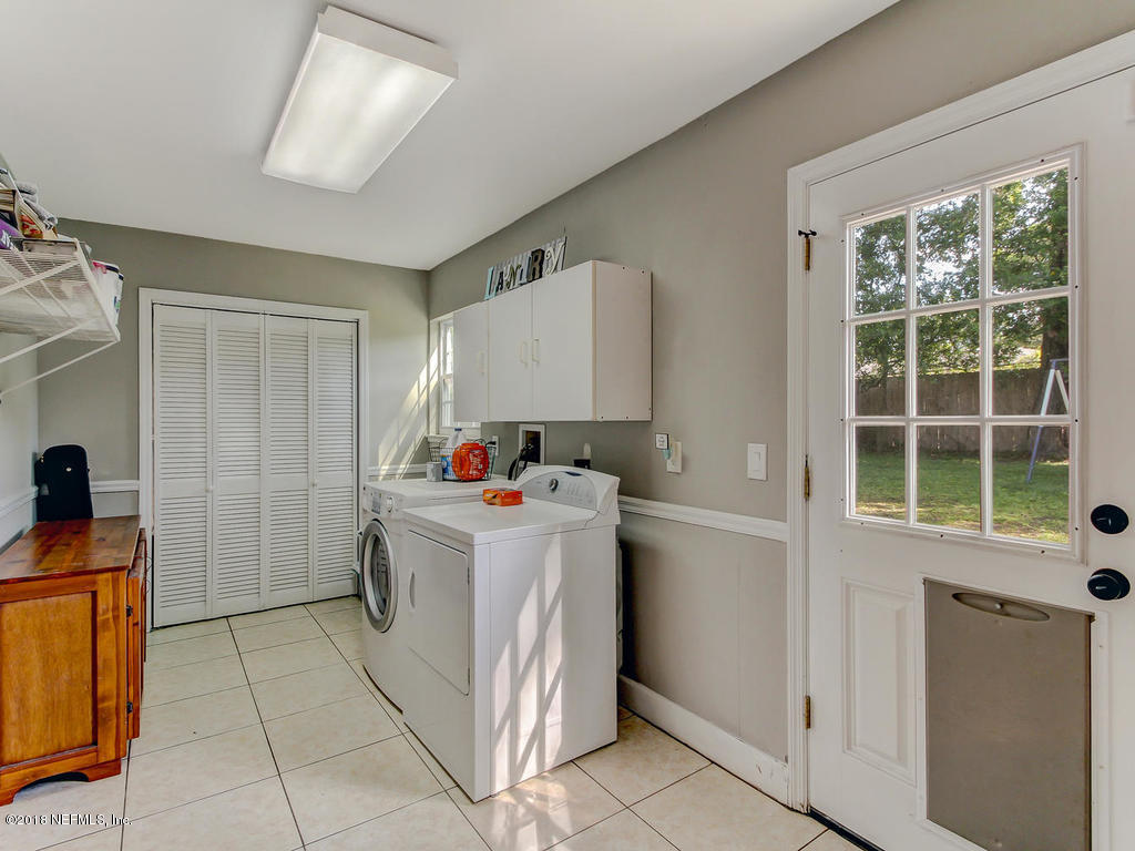 1041 Glen Echo Road Jacksonville, FL 32211 - Photo 32 of 40 a utility room with cabinets dryer and washer