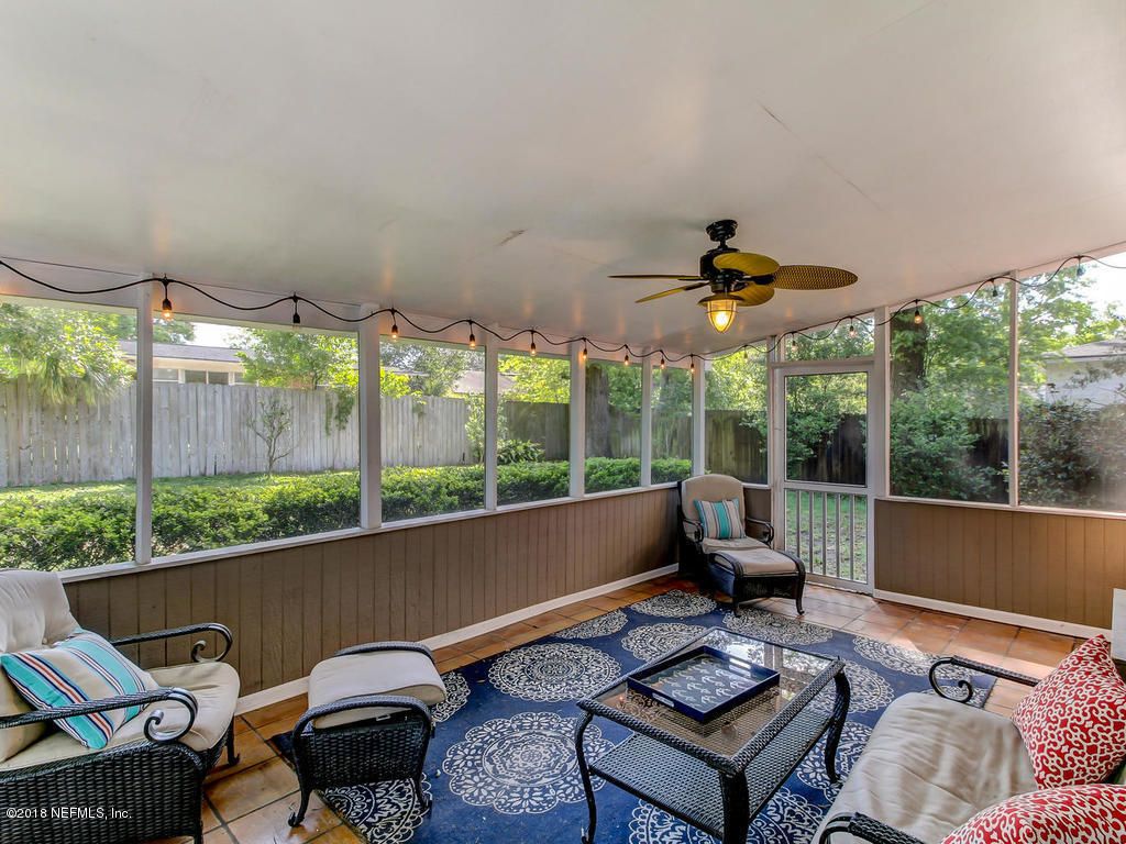 1041 Glen Echo Road Jacksonville, FL 32211 - Photo 33 of 40 a living room with furniture and a floor to ceiling window