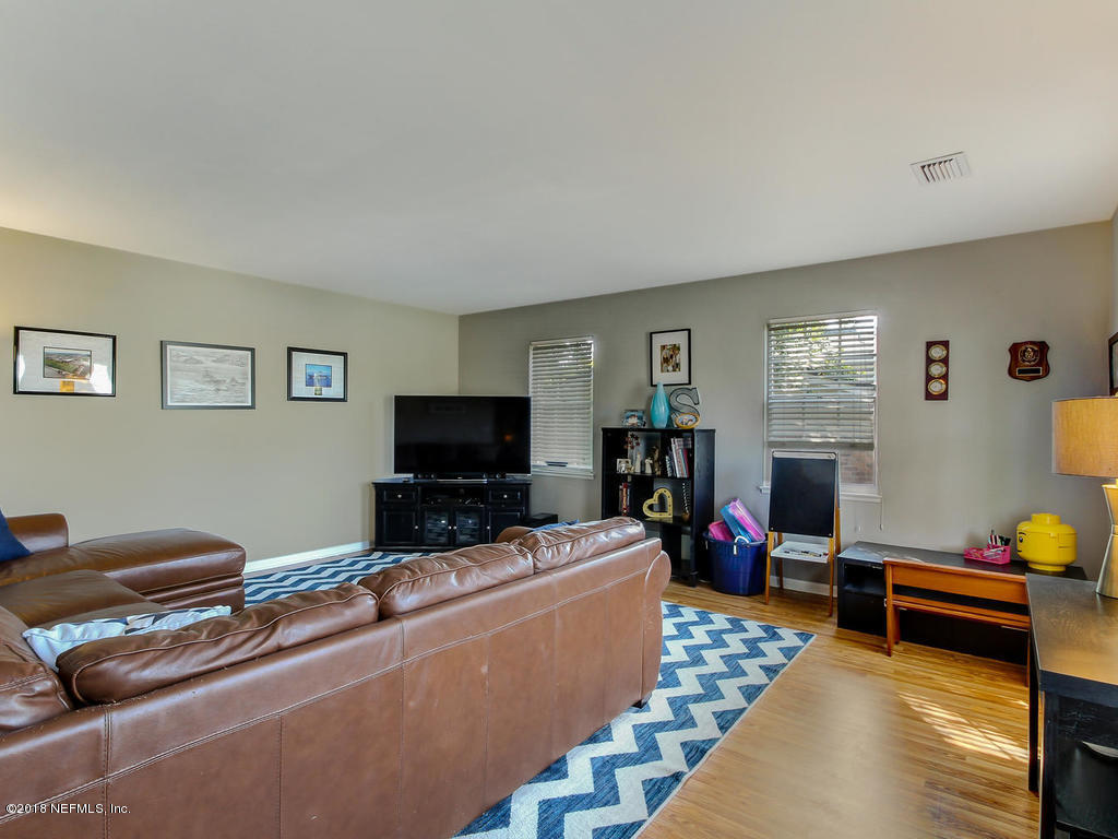 1041 Glen Echo Road Jacksonville, FL 32211 - Photo 7 of 40 a living room with furniture and a flat screen tv