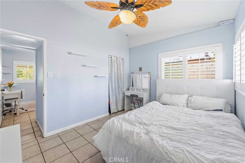 10363 Wagner Way Riverside, CA 92505 - Photo 13 of 26 a bedroom with a bed and a chandelier