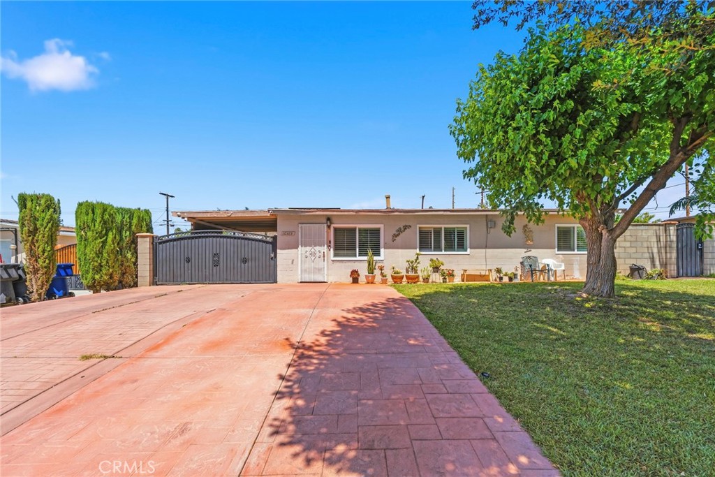 10363 Wagner Way Riverside, CA 92505 - Photo 2 of 26 a front view of a house with a yard and trees
