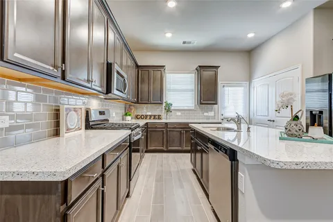 a kitchen with stainless steel appliances granite countertop lots of counter top space and a sink