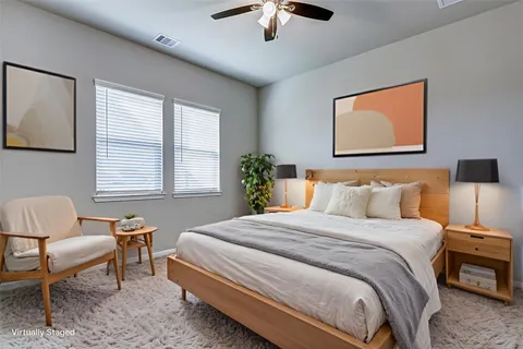 a bedroom with bed and a chandelier