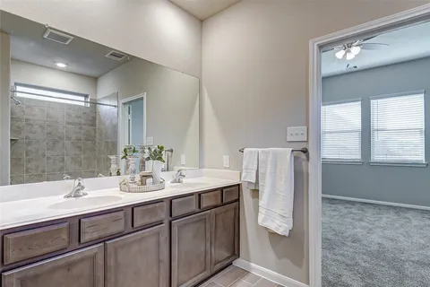 a bathroom with a double vanity sink and mirror