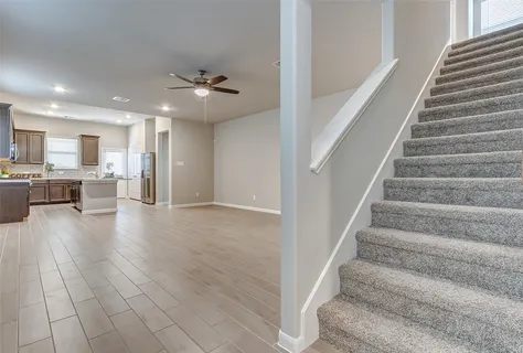 a view of an entryway with kitchen and windows