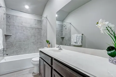 a bathroom with a sink a toilet and bathtub