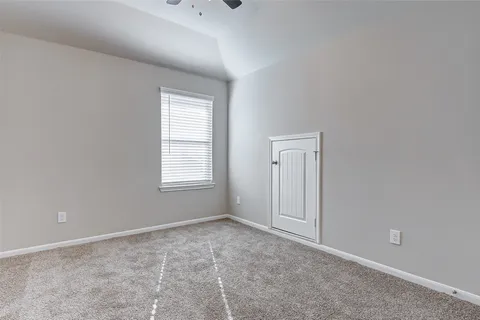 a view of an empty room and a window