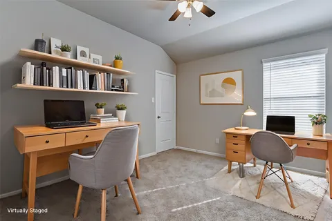 a workspace with furniture bookshelf and a window