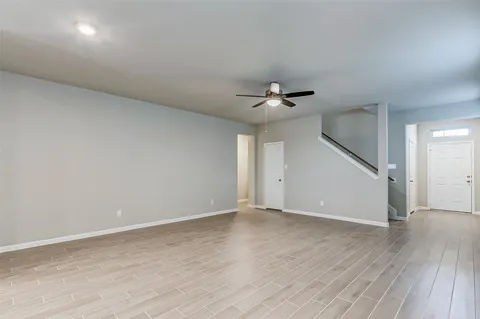 a view of an empty room with wooden floor