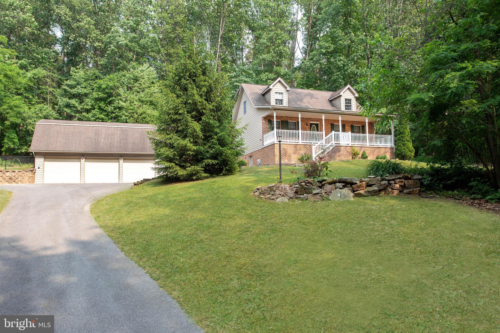 357 Lake Road Spring Grove, PA 17362 - Photo 1 of 35 a front view of a house with a garden