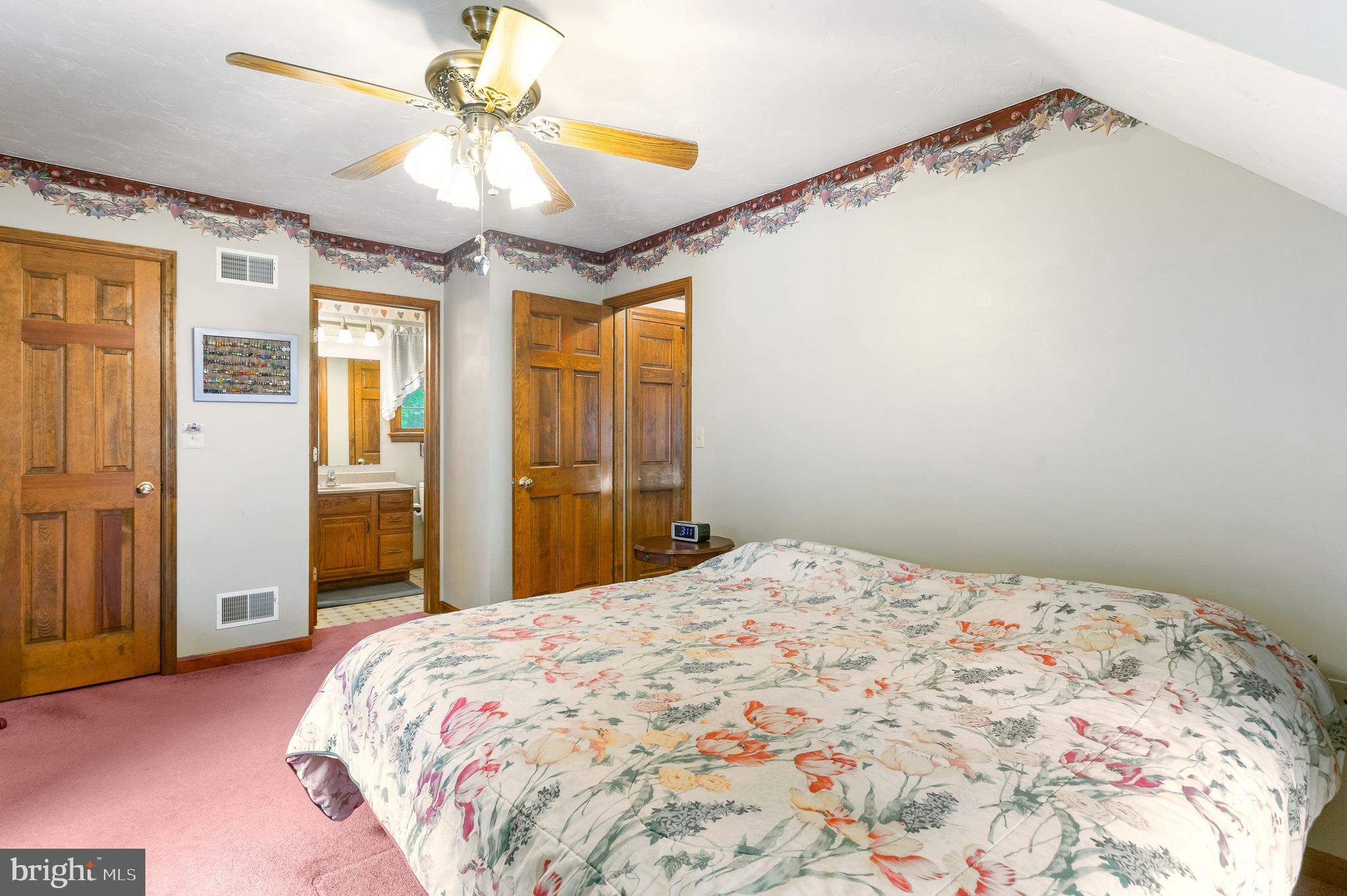 357 Lake Road Spring Grove, PA 17362 - Photo 26 of 35 a bedroom with a large bed and a chandelier