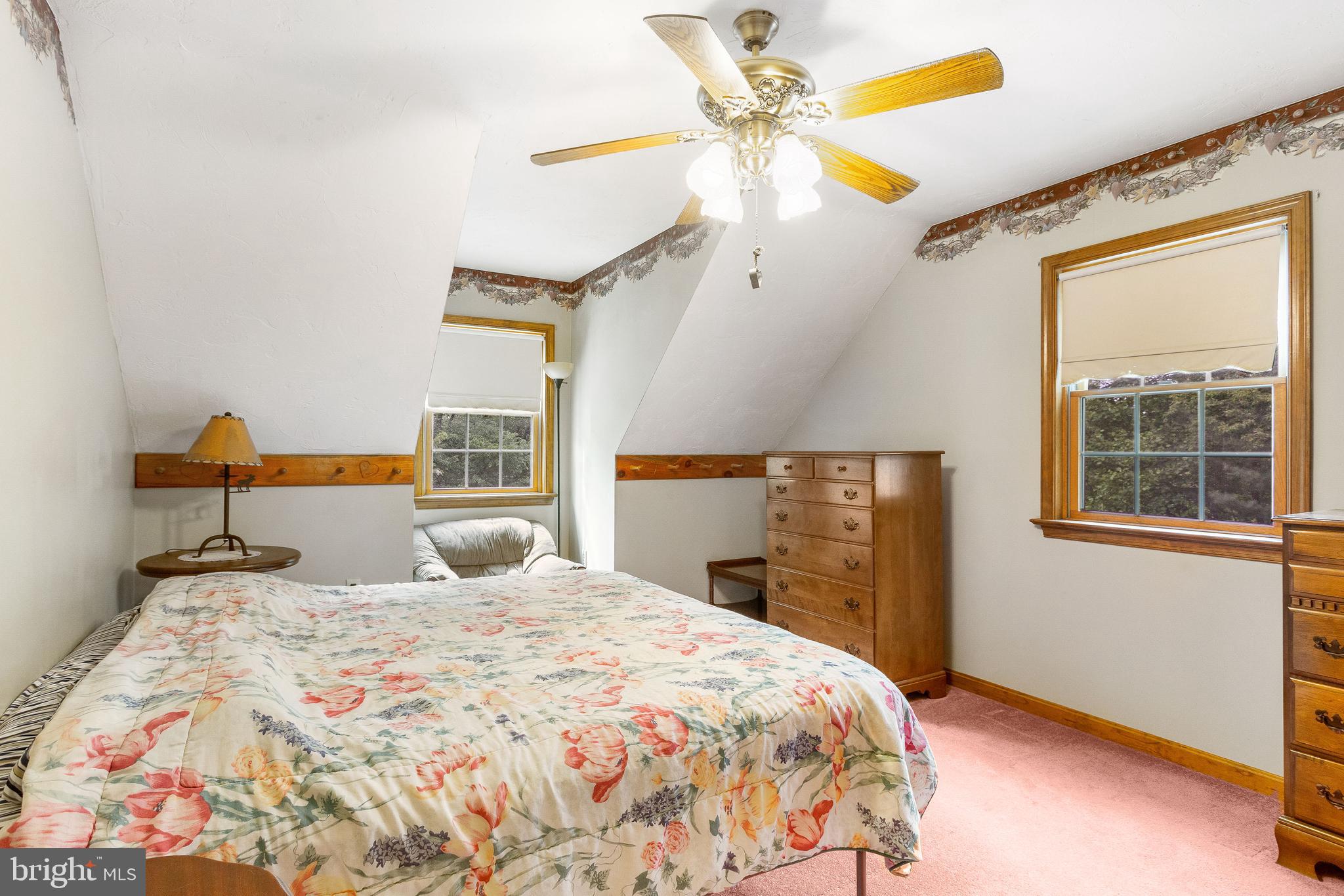 357 Lake Road Spring Grove, PA 17362 - Photo 27 of 35 a bedroom with a bed and a chandelier