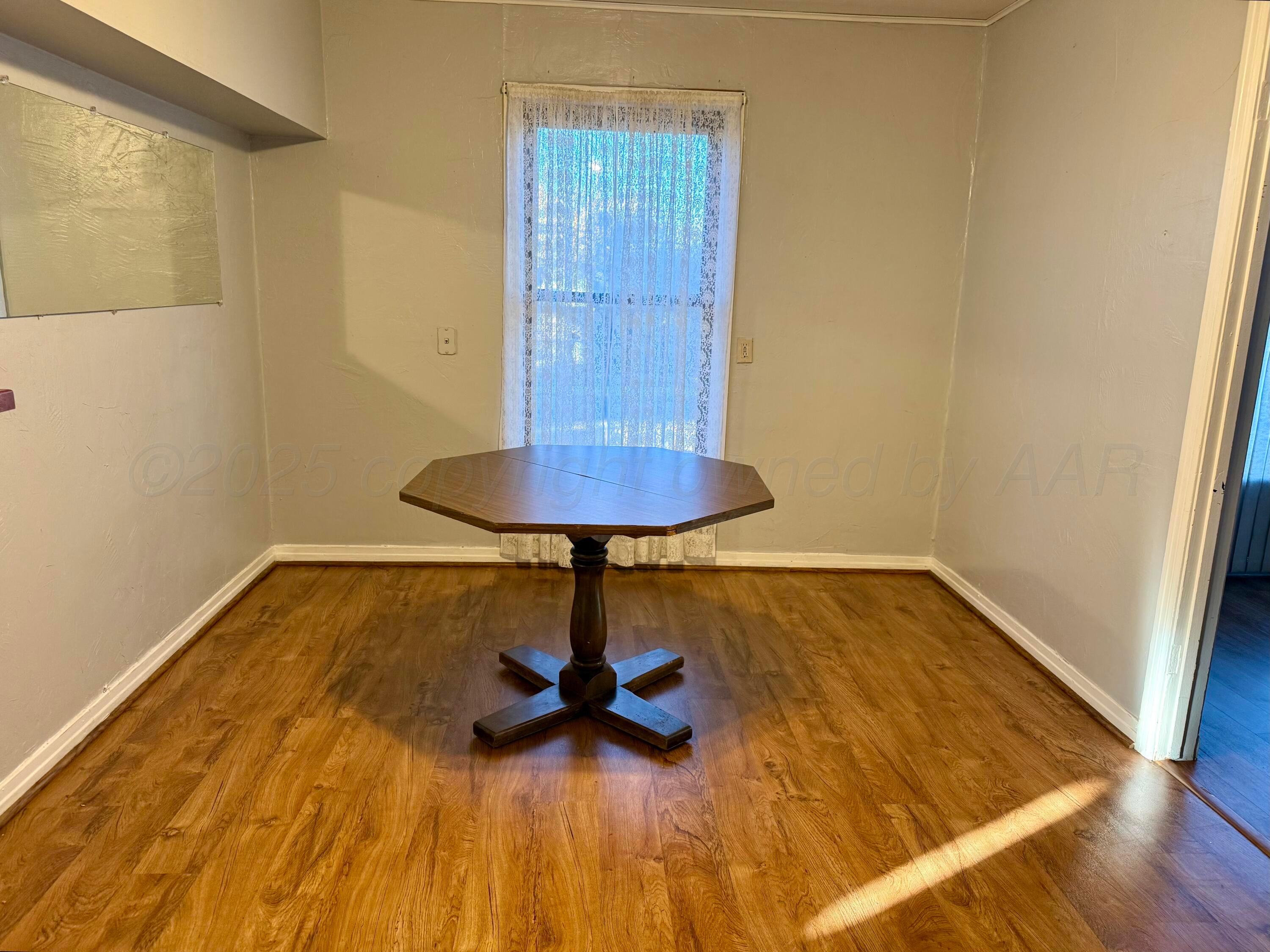 1405 Jennings Street Borger, TX 79007 - Photo 5 of 10 a view of a room with wooden floor and carpet
