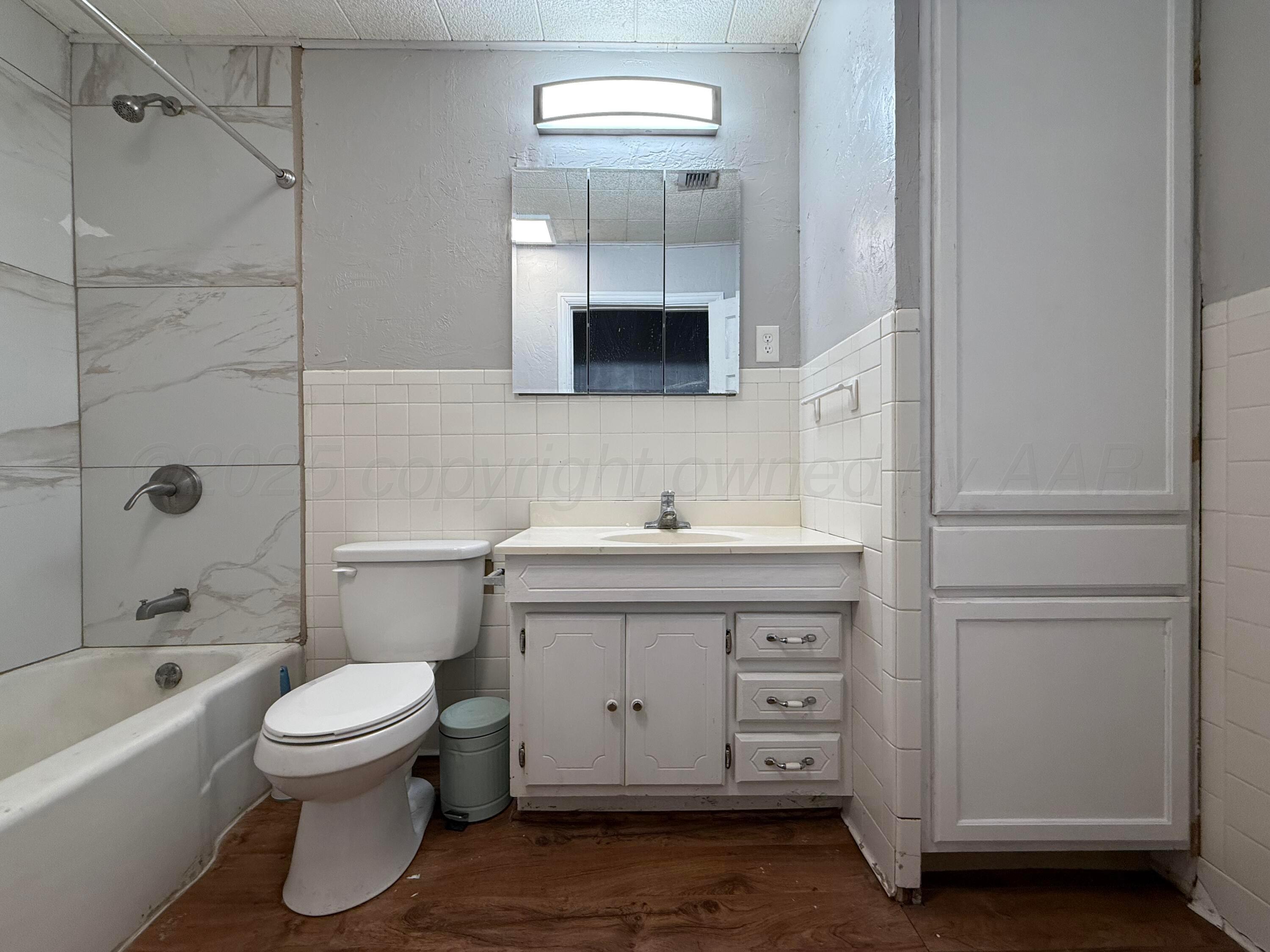 1405 Jennings Street Borger, TX 79007 - Photo 9 of 10 a bathroom with a double vanity sink a toilet and shower