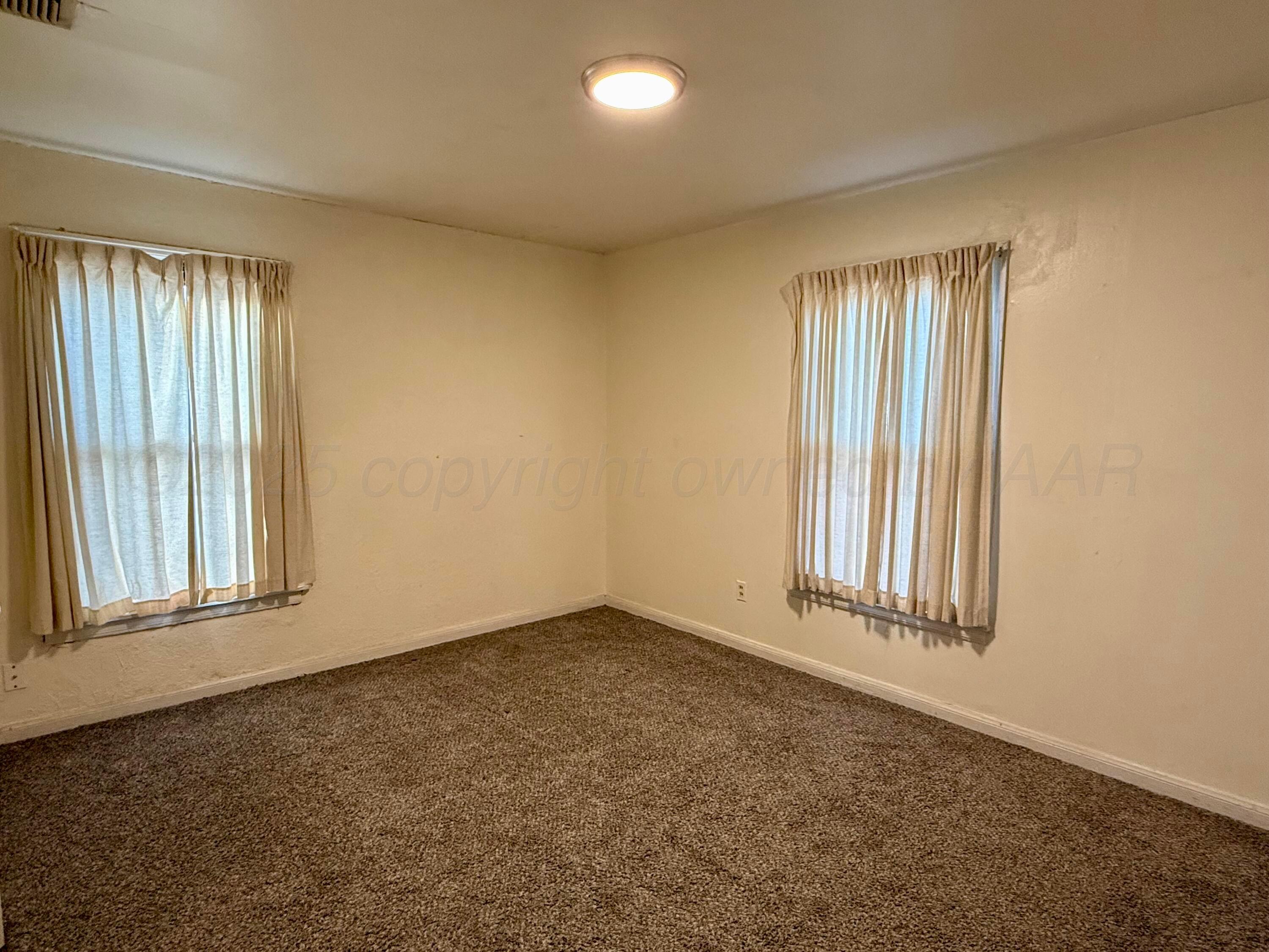 1405 Jennings Street Borger, TX 79007 - Photo 10 of 10 an empty room with windows