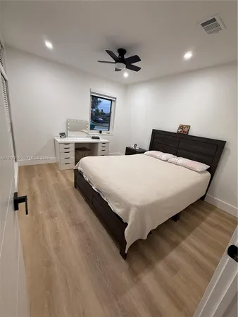 a bedroom with a bed and a night stand