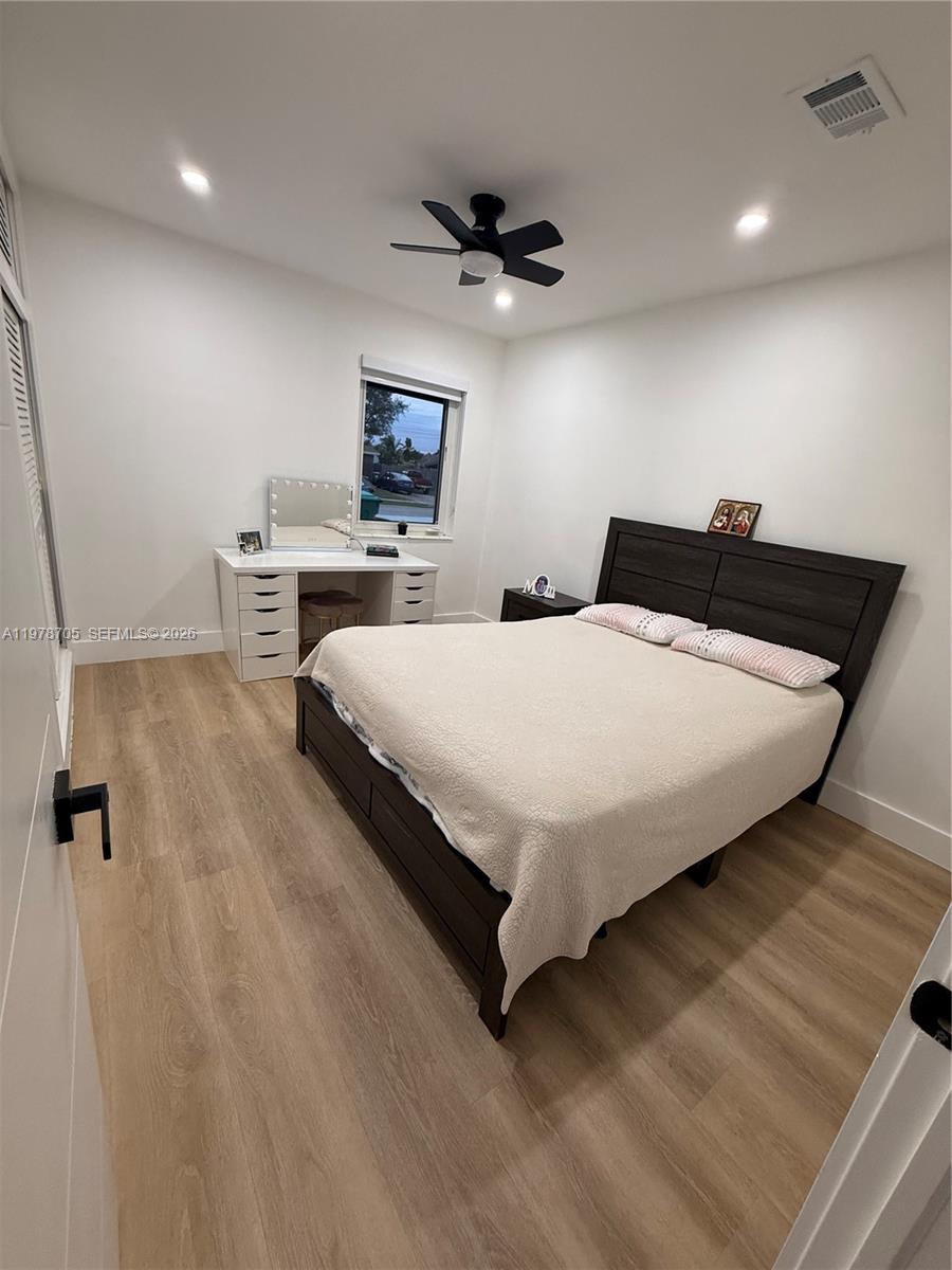 15915 Southwest 103rd Place Miami, FL 33157 - Photo 11 of 17 a bedroom with a bed and a night stand