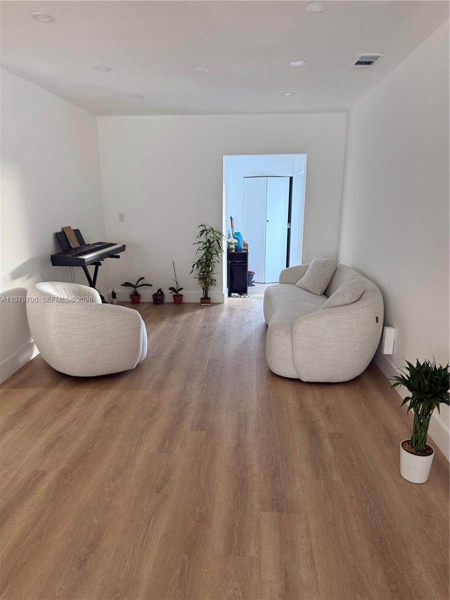 15915 Southwest 103rd Place Miami, FL 33157 - Photo 13 of 17 a living room with furniture and a potted plant